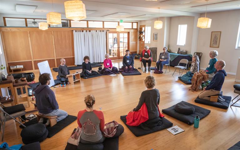 For Organizations students in circle on mats in wood floor classroom @ mindfulness northwest bellingham wa