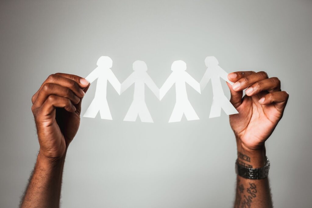Man holding 4 cutout people